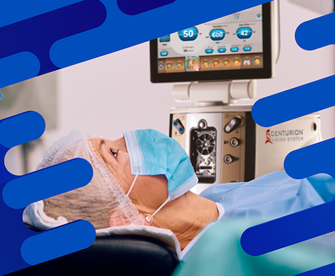 Patient wearing a surgical cap and mask lying beneath a Centurion Vision System monitor during an ophthalmic procedure.