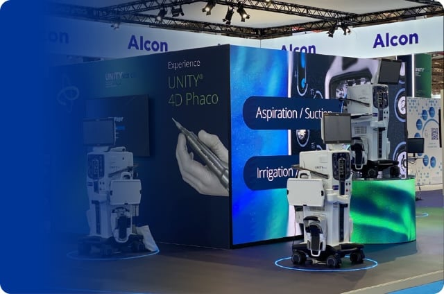 Alcon exhibition booth featuring ophthalmic surgical equipment, large digital displays, and UNITY™ 4D Phaco technology at a trade show.
