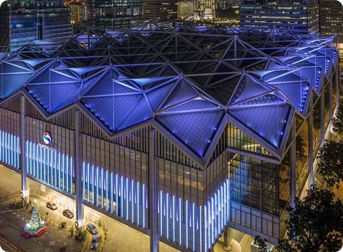 Modern city building with blue lighting at night