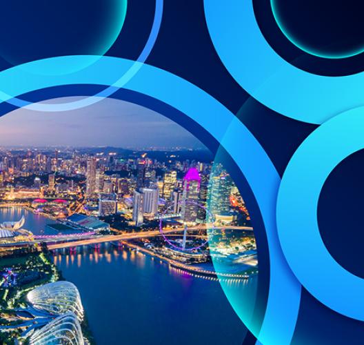 Illuminated city skyline at night with abstract blue circular overlay