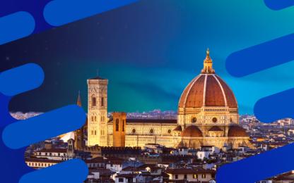 View of Florence, Italy at dusk featuring the illuminated Cathedral of Santa Maria del Fiore (Duomo) with its red dome