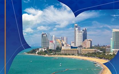 A tropical coastal city with modern high-rise buildings along a curved sandy beach, turquoise sea waters, and small boats near the shore, displayed within a stylized blue graphic frame