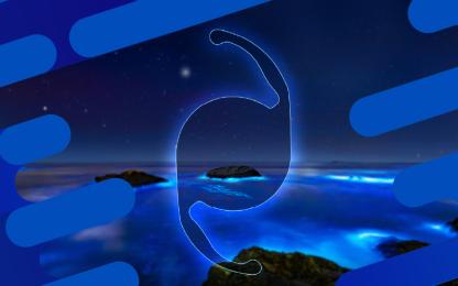 Stylized intraocular lens graphic glowing above a blue illuminated seascape at night, framed by blue decorative design elements
