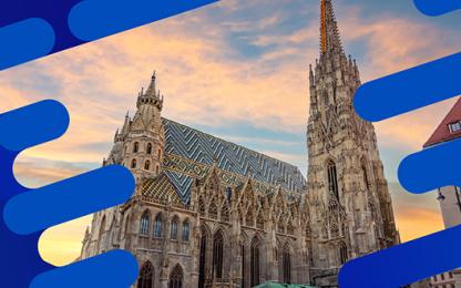 Cathedral with a patterned tiled roof and tall spire at sunset, framed by blue graphic elements